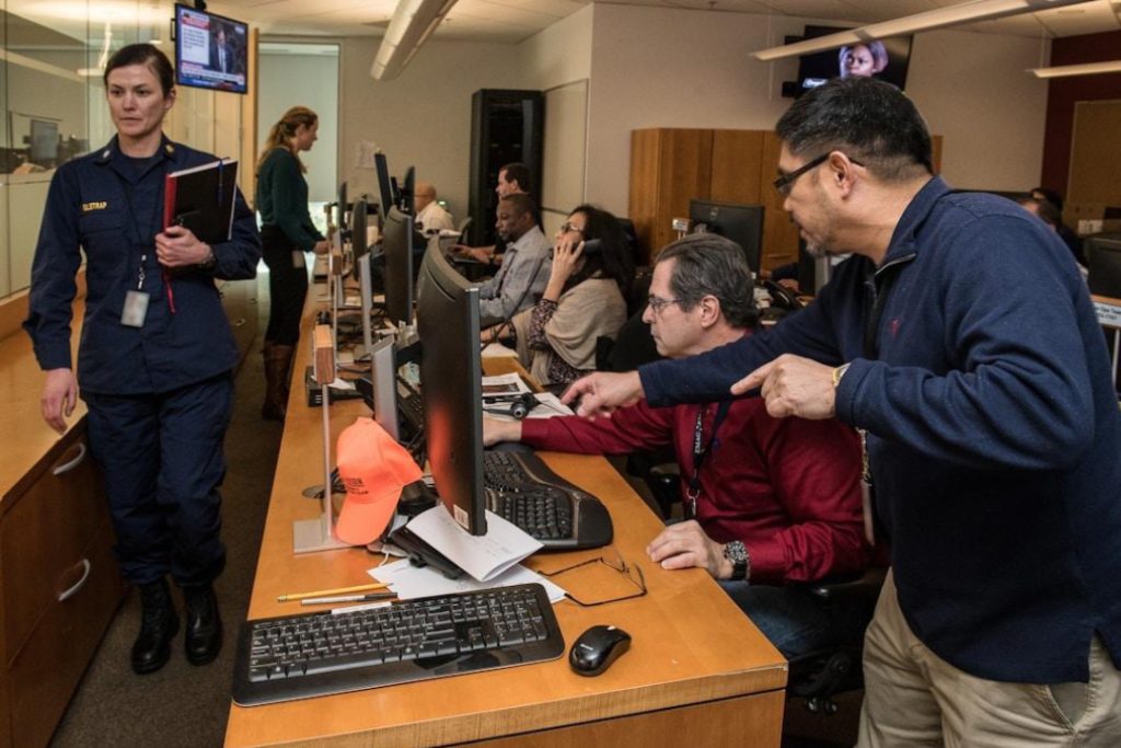 Team members collaborating in an office conference room, leveraging technology for enhanced knowledge management in finance